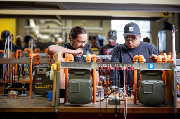Students learning gas fitter course skills at Pipe Trades Technologies through practical pipe exam training